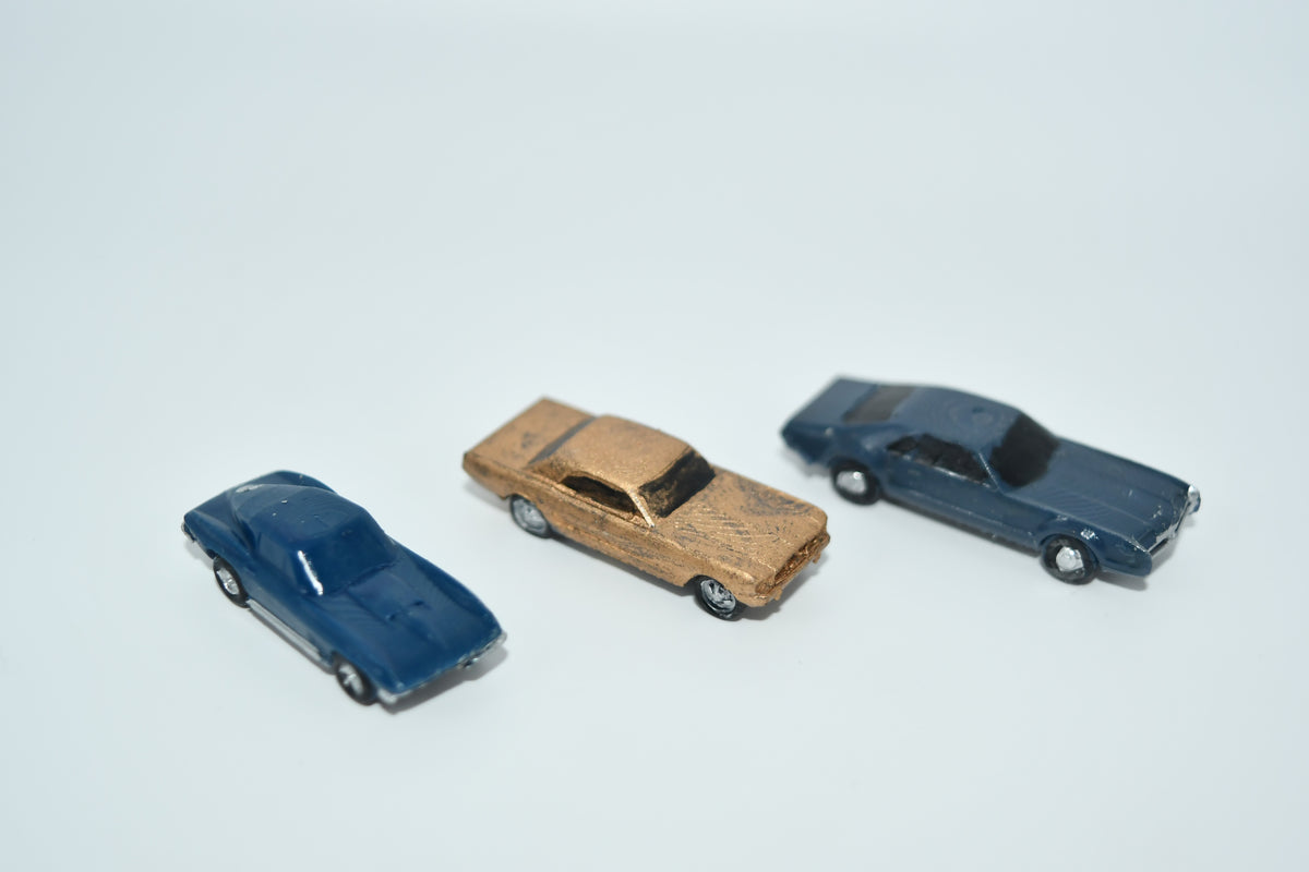 Cars from the 1960s. Including a Mustang, Corvette, and Olds in HO scale